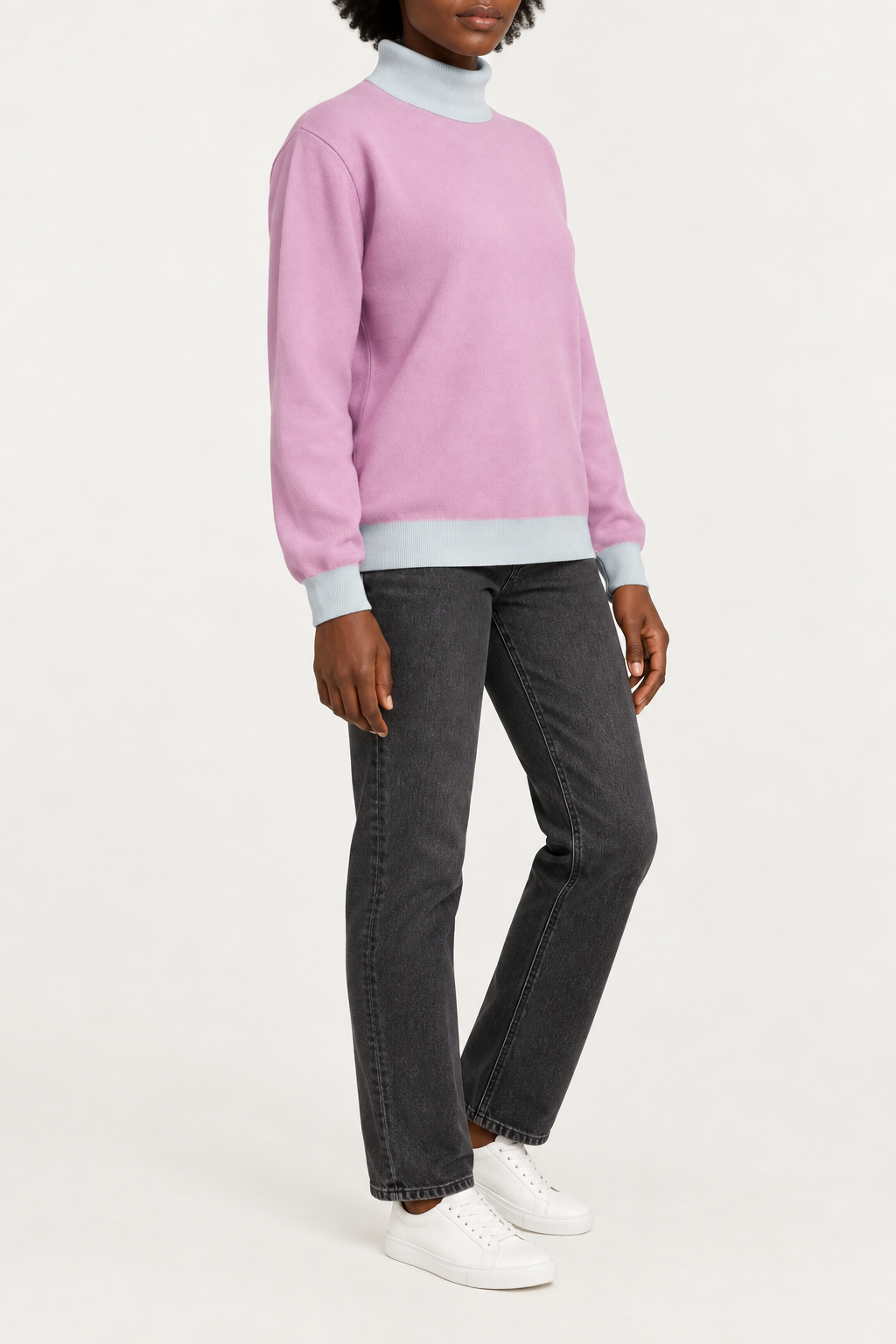 Three-quarter view showing the Lilac silhouette and Powder hem of Soft Horizon Turtleneck in Lilac with Powder Trim.