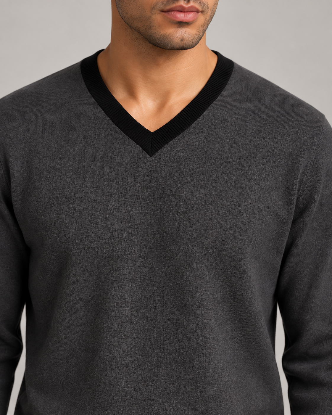 Close-up showing the Black V neckline and Charcoal knit texture of Quiet Angle V-Neck in Charcoal with Black Trim.