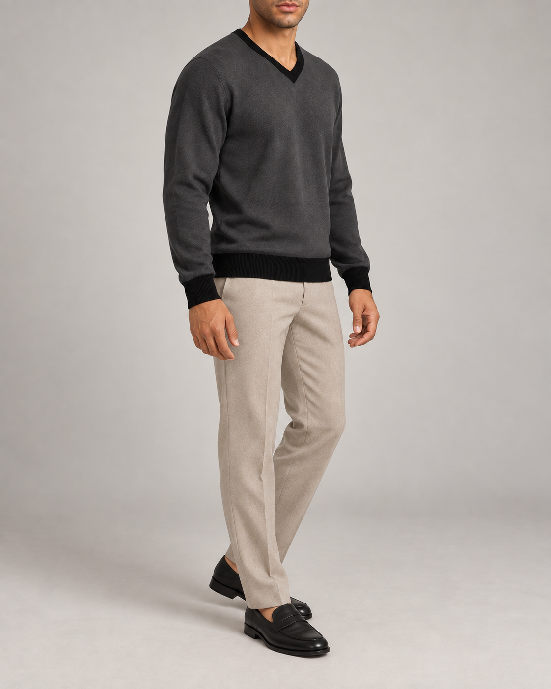 Three-quarter view showing the Charcoal classic shape and Black hem of Quiet Angle V-Neck in Charcoal with Black Trim.