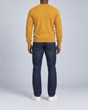 Rear view showing the plain Mustard back and ribbed hem of Quiet Angle V-Neck Sweater in Mustard.