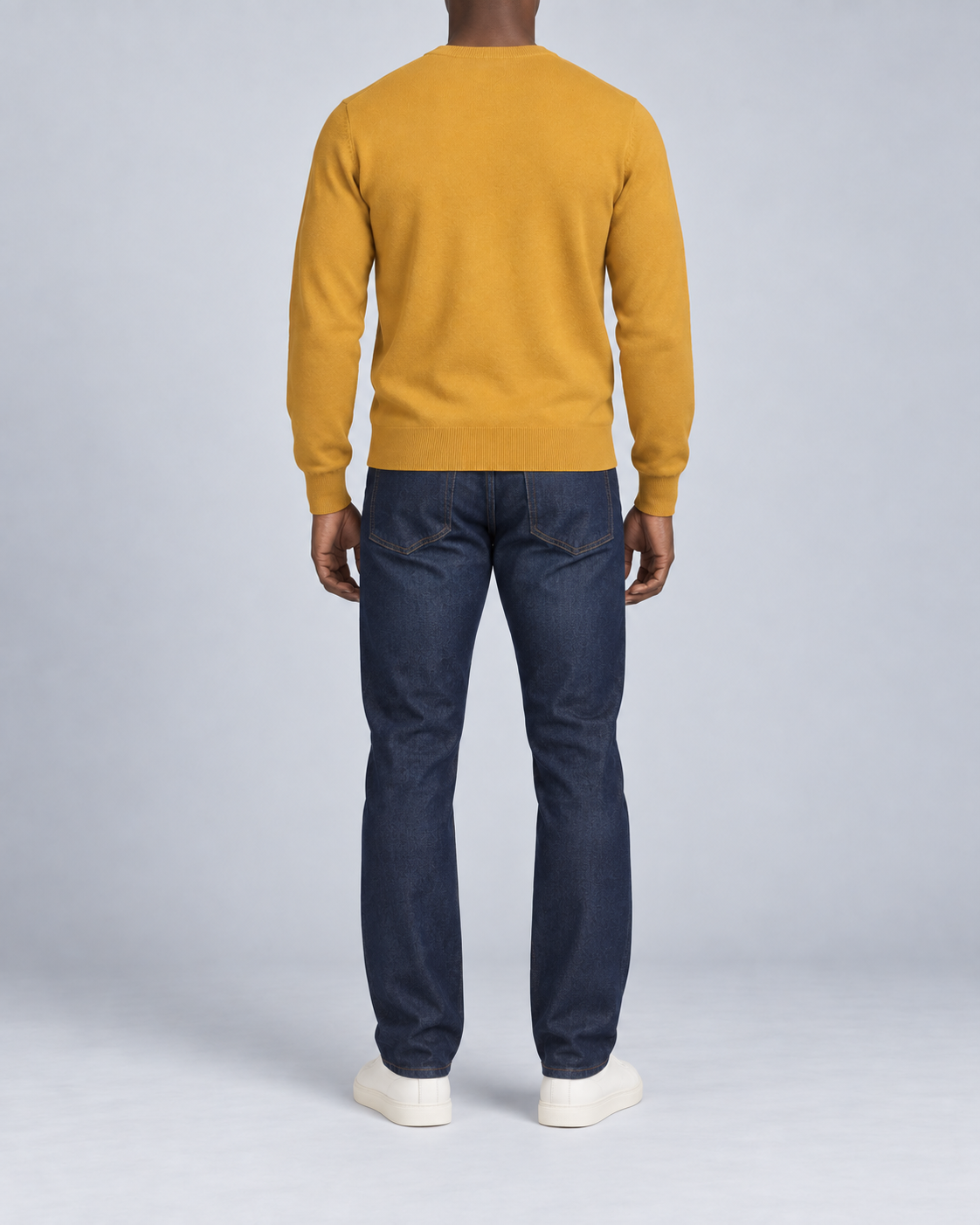 Rear view showing the plain Mustard back and ribbed hem of Quiet Angle V-Neck Sweater in Mustard.
