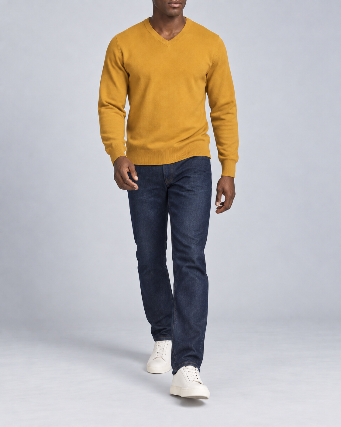 Walking view showing the Mustard knit drape of Quiet Angle V-Neck Sweater in Mustard.