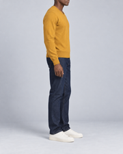 Side view showing the Mustard classic fit and long sleeves of Quiet Angle V-Neck Sweater in Mustard.