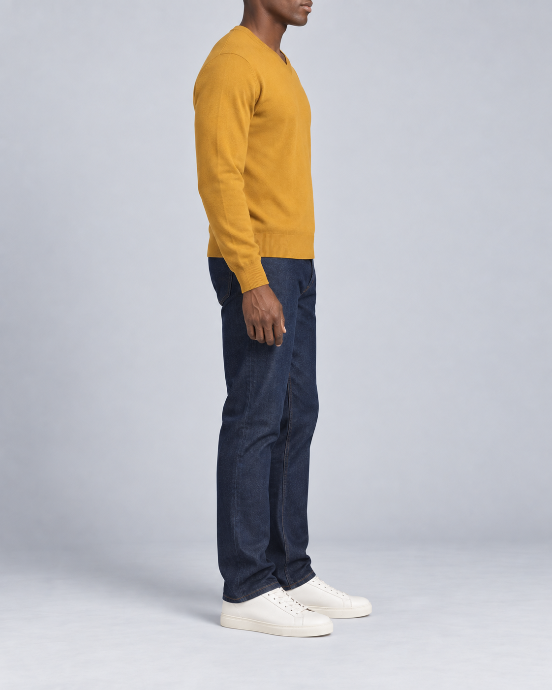 Side view showing the Mustard classic fit and long sleeves of Quiet Angle V-Neck Sweater in Mustard.