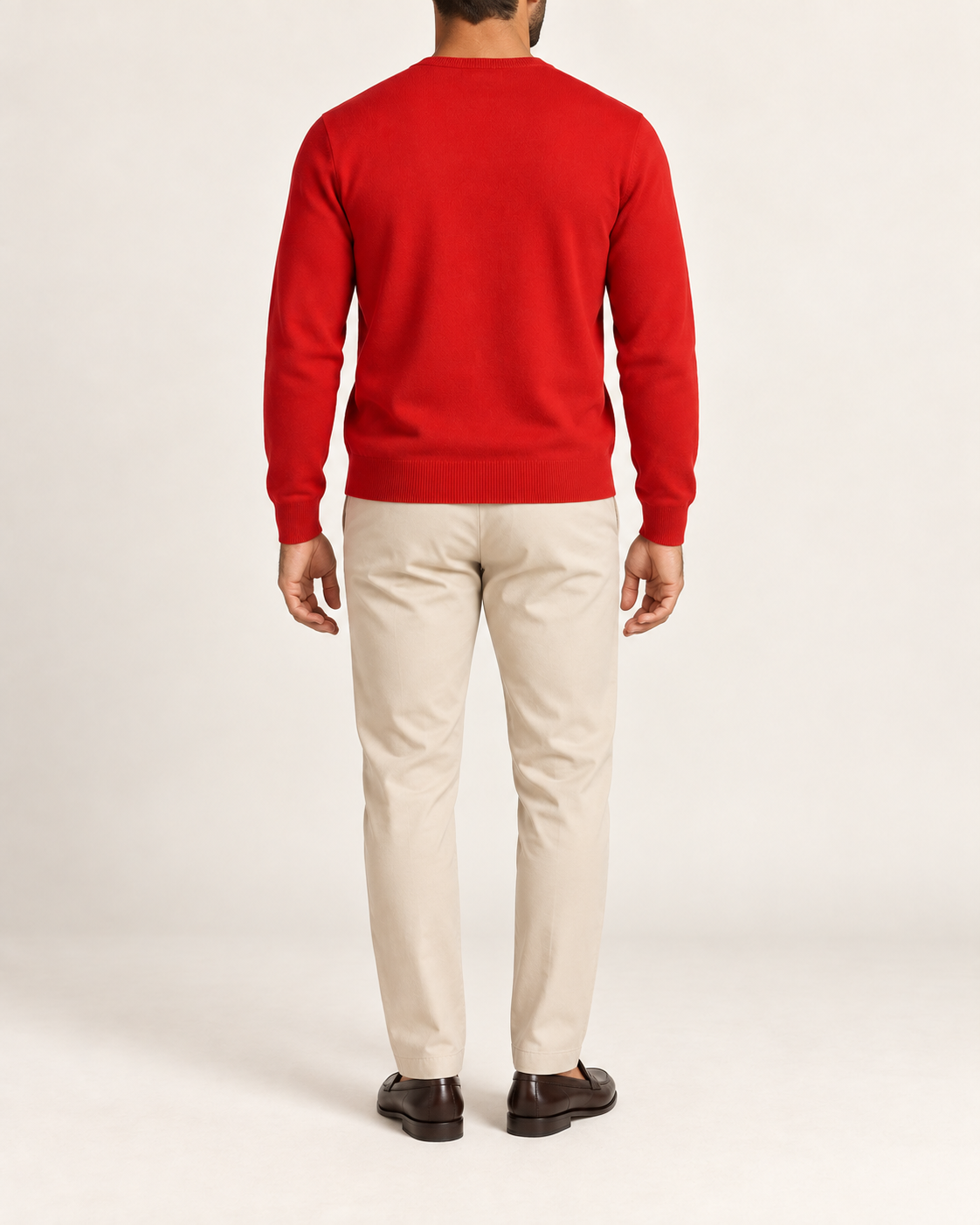 Rear view showing the plain Chili red back and tonal hem of Quiet Angle V-Neck Sweater in Chili.