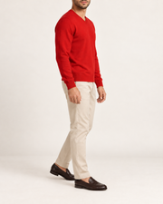 Side view showing the Chili red classic fit and long sleeves of Quiet Angle V-Neck Sweater in Chili.
