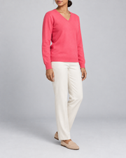 Three-quarter view showing the Hot Pink classic fit and long sleeves of Soft Angle V-Neck Sweater in Hot Pink.