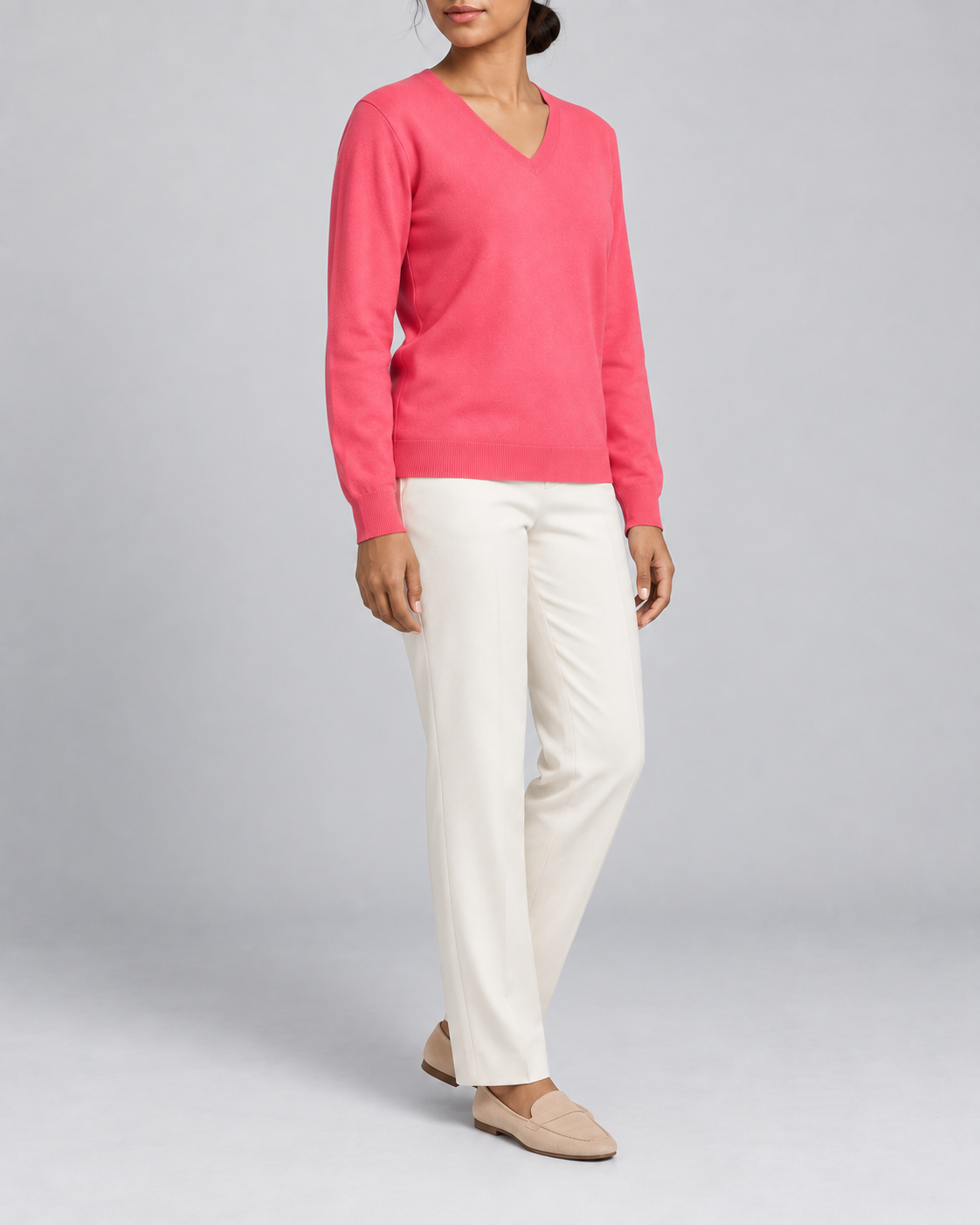 Three-quarter view showing the Hot Pink classic fit and long sleeves of Soft Angle V-Neck Sweater in Hot Pink.