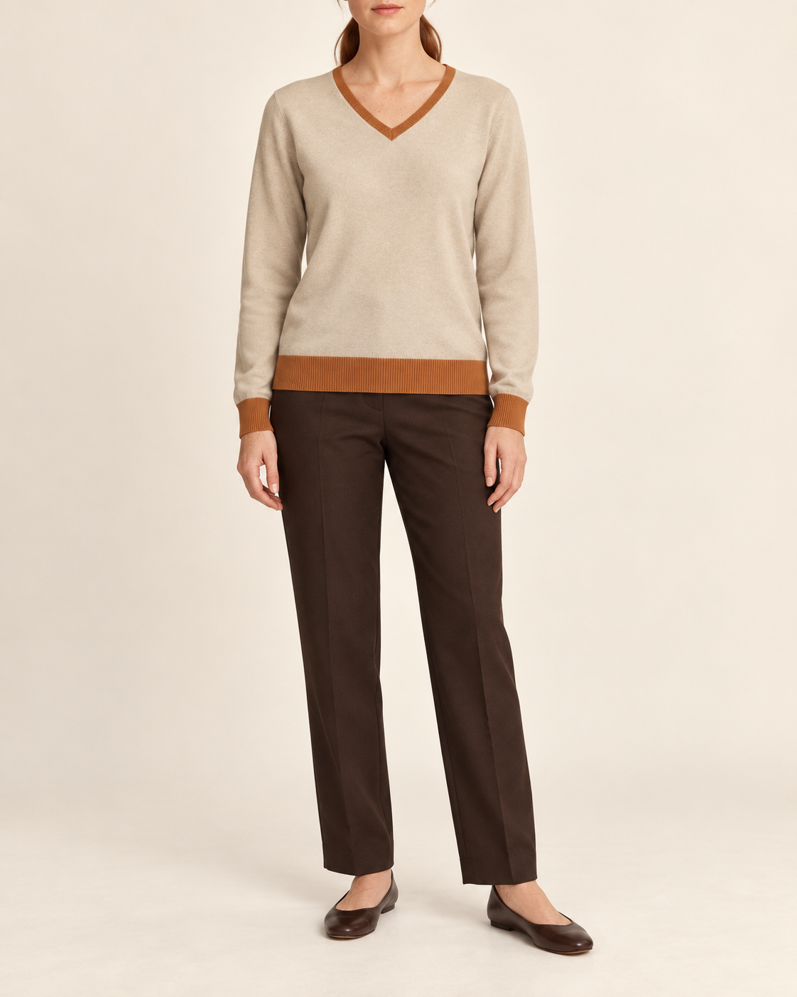 Hero front showing the plain Beige knit and Rust V neckline of Soft Angle V-Neck in Beige with Rust Trim.