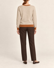 Rear view showing the plain Beige back and Rust hem of Soft Angle V-Neck in Beige with Rust Trim.