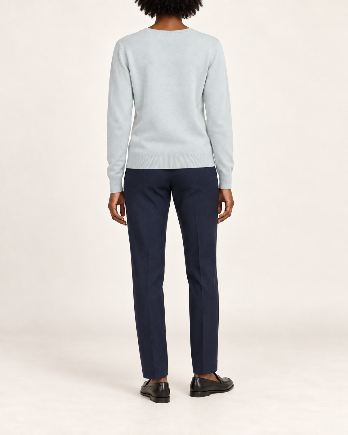 Rear view showing the plain Powder blue back and tonal hem of Soft Angle V-Neck Sweater in Powder.