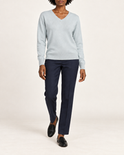 Walking view showing the Powder blue knit drape of Soft Angle V-Neck Sweater in Powder.