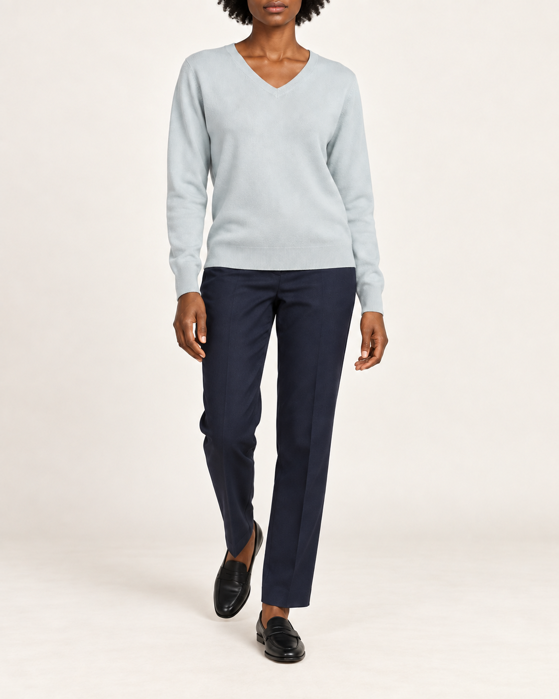 Walking view showing the Powder blue knit drape of Soft Angle V-Neck Sweater in Powder.