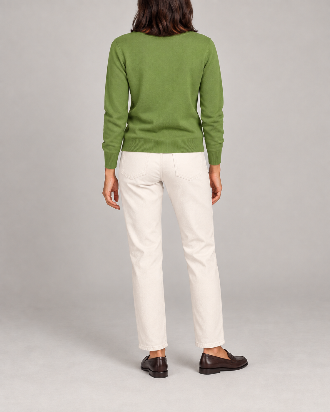 Rear view showing the plain Grass green back and tonal hem of Soft Angle V-Neck Sweater in Grass.