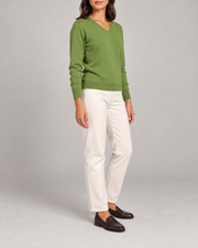 Three-quarter view showing the Grass green classic fit and long sleeves of Soft Angle V-Neck Sweater in Grass.