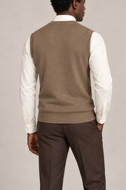 Quiet Layer V-Neck Vest in Peanut, elegantly layered on a male model, rear three-quarter view.