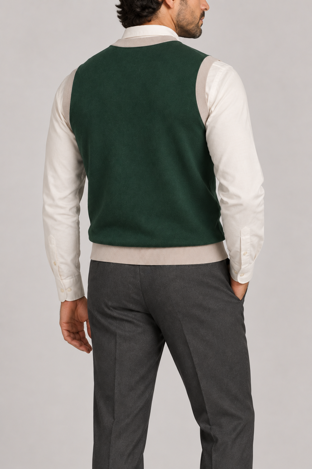 Quiet Layer V-Neck Vest in Pine with Coco Trim, elegantly layered on a male model, rear three-quarter view.