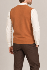 Quiet Layer V-Neck Vest in Rust, elegantly layered on a male model, rear three-quarter view.