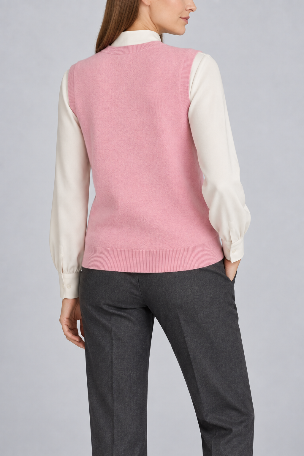 Soft Outline V-Neck Vest in Pink, elegantly layered on a female model, rear three-quarter view.
