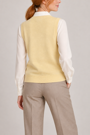 Soft Outline V-Neck Vest in Mellow, elegantly layered on a female model, rear three-quarter view.