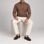 Seated studio view showing the Toffee knit drape and ribbed cuffs of Open Pace Quarter-Zip Sweater in Toffee.
