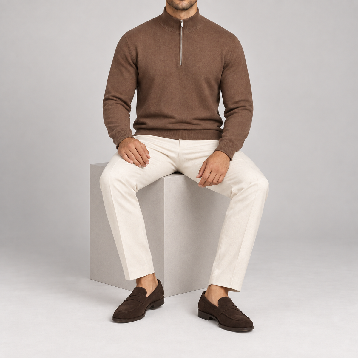 Seated studio view showing the Toffee knit drape and ribbed cuffs of Open Pace Quarter-Zip Sweater in Toffee.