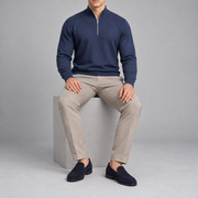 Seated studio view showing the Navy knit drape and long sleeves of Open Pace Quarter-Zip Sweater in Navy.