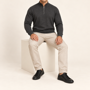 Seated studio view showing Charcoal knit drape and long sleeves of Open Pace Quarter-Zip Sweater in Charcoal.