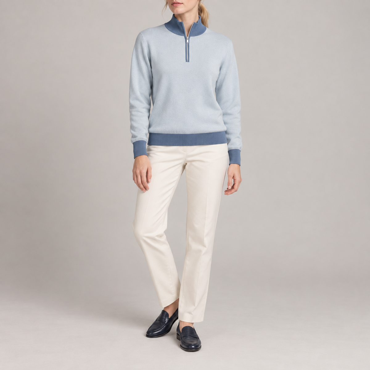 Front studio view showing Powder knit and contrasting Denim collar cuffs and hem of Soft Pace Quarter-Zip in Powder with Denim Trim.