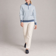 Walking studio view showing Powder knit drape and blue contrasting edges of Soft Pace Quarter-Zip in Powder with Denim Trim.