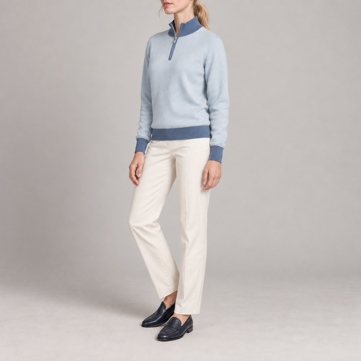 Three-quarter studio view showing the Powder silhouette with Denim ribbed trim of Soft Pace Quarter-Zip in Powder with Denim Trim.