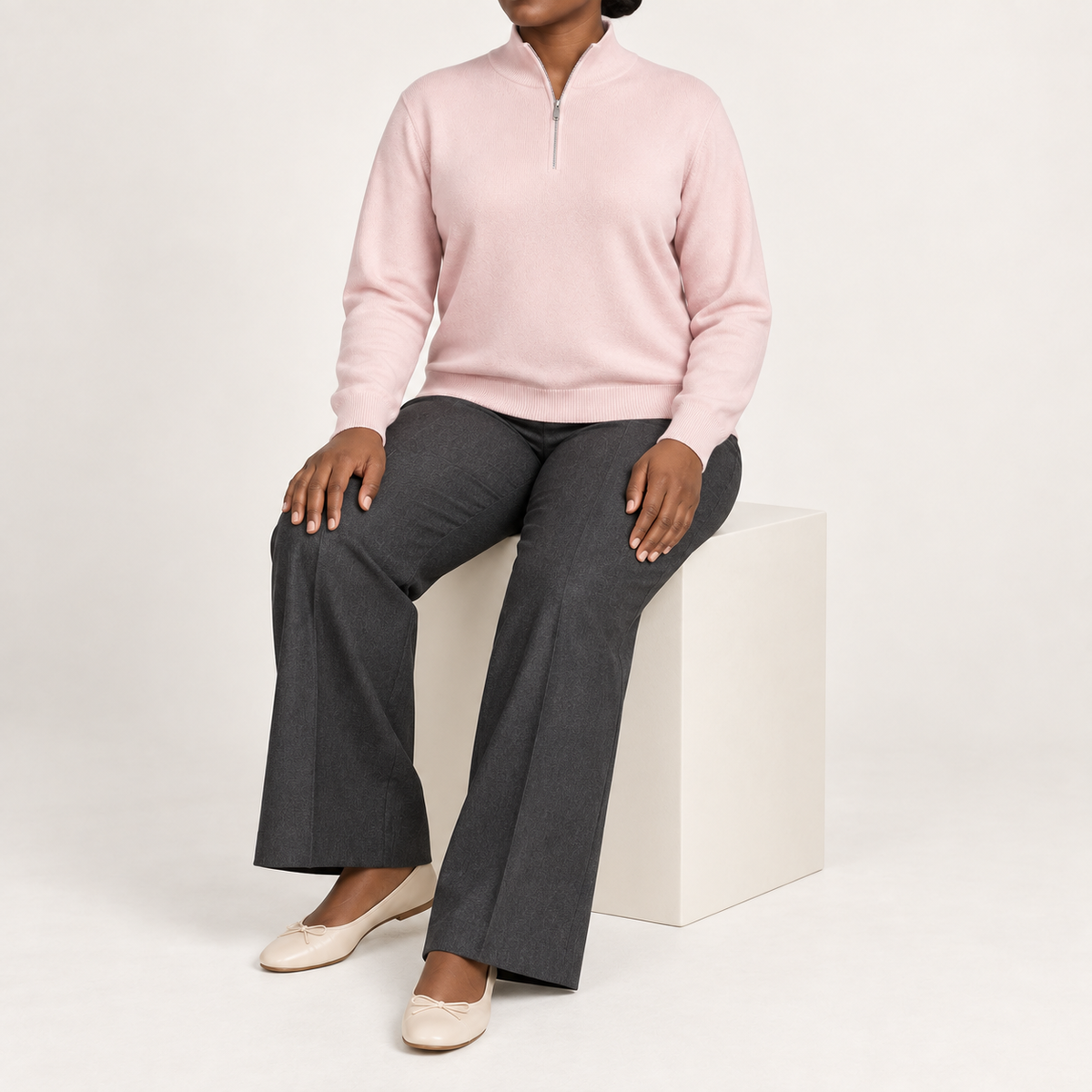 Seated studio view showing Lt Pink knit drape and long sleeves of Soft Pace Quarter-Zip Sweater in Lt Pink.