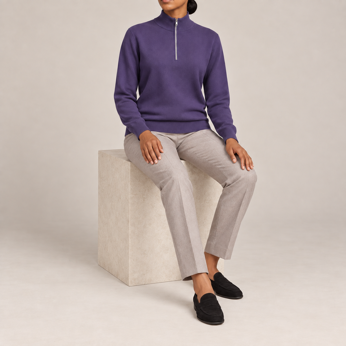 Seated studio view showing Violet knit drape and long sleeves of Soft Pace Quarter-Zip Sweater in Violet.