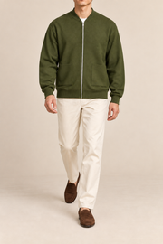Walking studio view showing knit drape of Afterlight Knit Bomber in Olive.