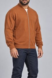 Three-quarter studio view showing the bomber silhouette of Afterlight Knit Bomber in Rust.