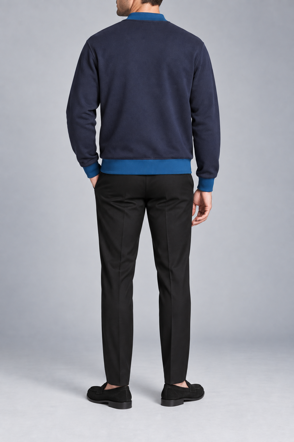 Rear studio view showing plain knit back and ribbed hem of Afterlight Knit Bomber in Navy with Yale Blue Trim.