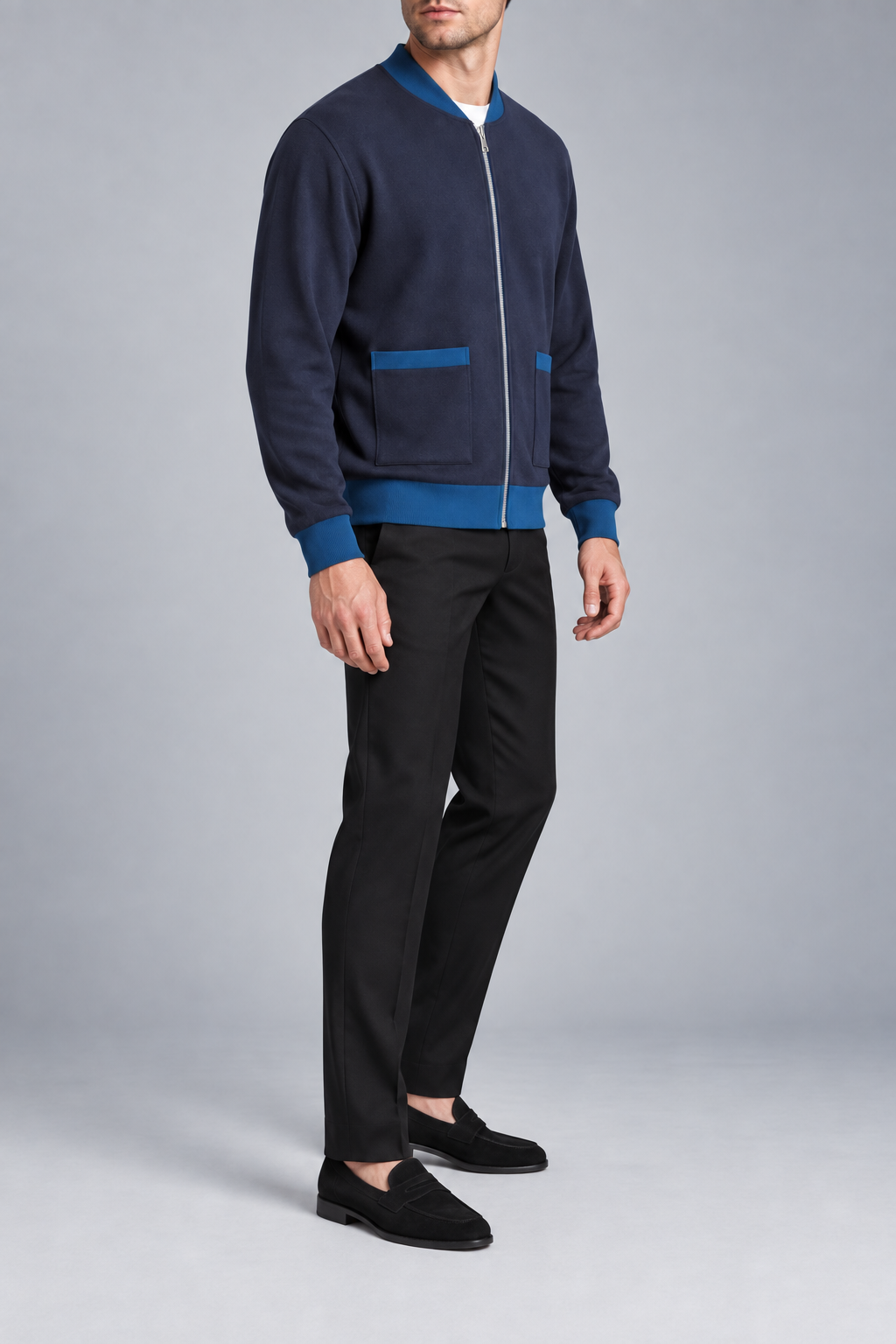 Three-quarter studio view showing the bomber silhouette of Afterlight Knit Bomber in Navy with Yale Blue Trim.