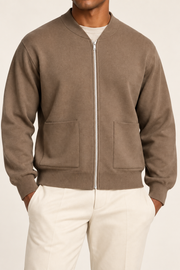 Close-up studio view showing low collar, zipper and fine knit texture of Afterlight Knit Bomber in Peanut.