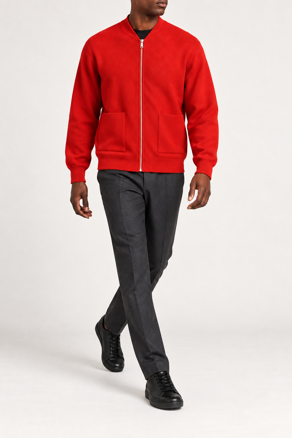 Walking studio view showing knit drape and front pockets of Afterlight Knit Bomber in Chili.