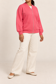 Three-quarter studio view showing the bomber silhouette of Soft Afterlight Knit Bomber in Hot Pink.