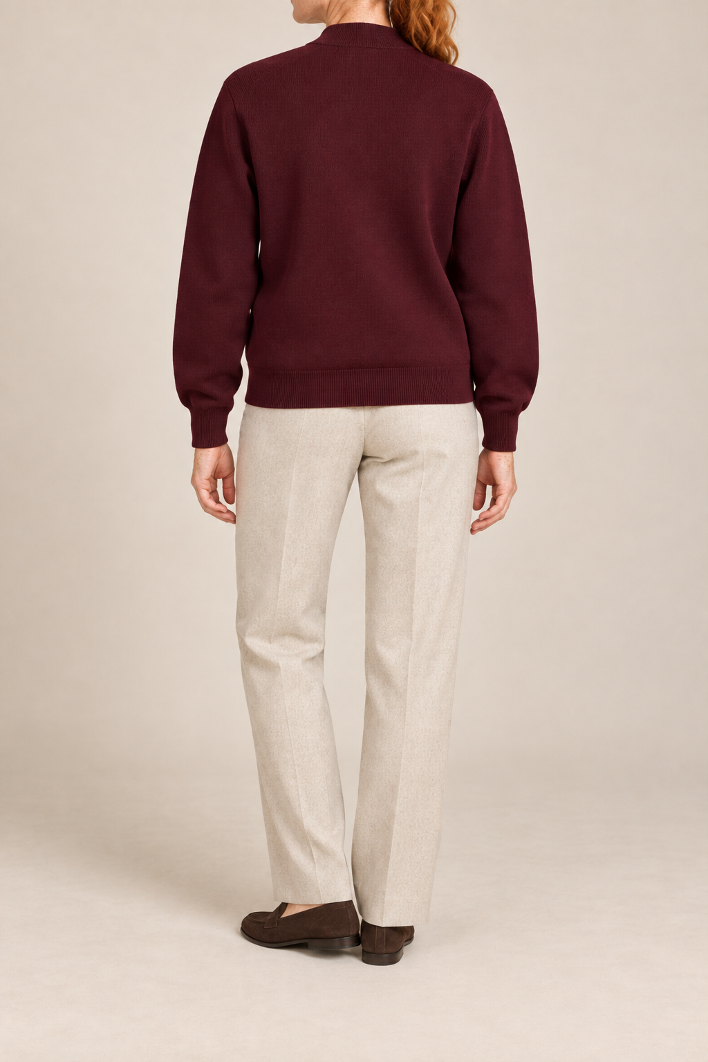 Rear studio view showing plain knit back and ribbed hem of Soft Afterlight Knit Bomber in Burgundy.