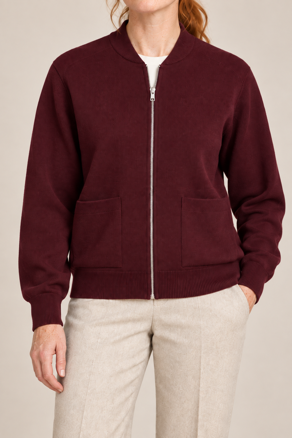 Close-up studio view showing low collar, zipper and fine knit texture of Soft Afterlight Knit Bomber in Burgundy.