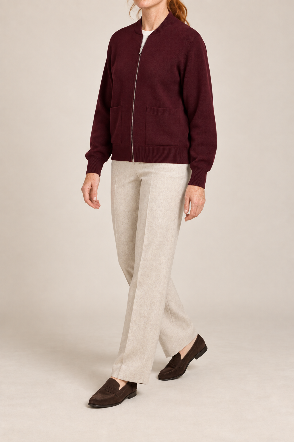 Three-quarter studio view showing the bomber silhouette of Soft Afterlight Knit Bomber in Burgundy.