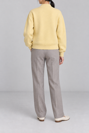 Rear studio view showing plain knit back and ribbed hem of Soft Afterlight Knit Bomber in Mellow.