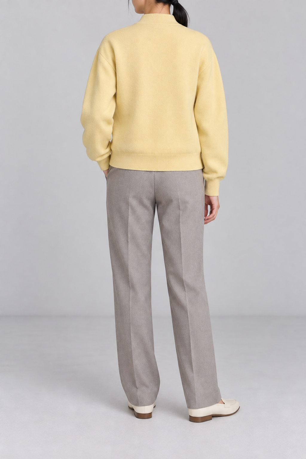 Rear studio view showing plain knit back and ribbed hem of Soft Afterlight Knit Bomber in Mellow.