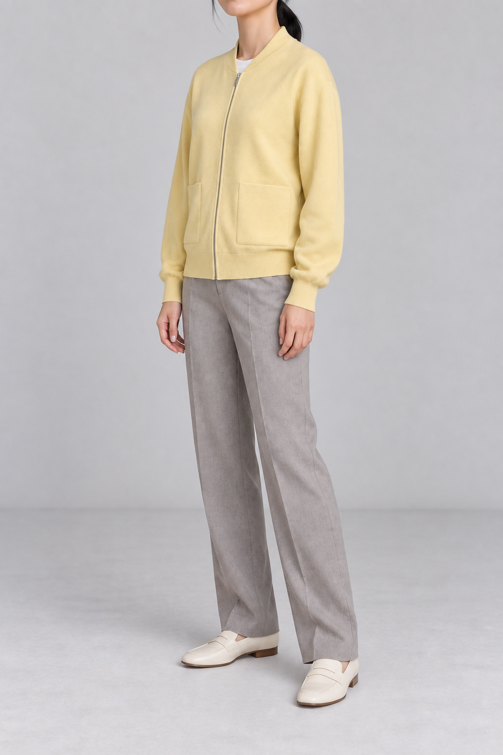 Three-quarter studio view showing the bomber silhouette of Soft Afterlight Knit Bomber in Mellow.