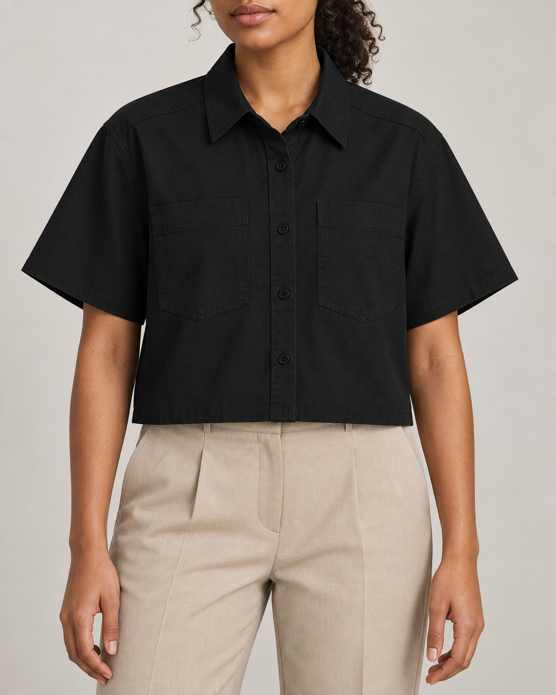 Front studio view of Quiet Line Crop Shirt in Black, showing the pointed collar, twin chest pockets and plain cropped shape.