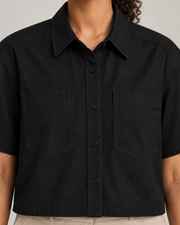 Detail of Quiet Line Crop Shirt in Black, showing collar stitching, black buttons and woven texture.