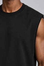 Detail of Raw Form Terry Tank in Black, showing the ribbed neckline, terry texture and frayed armhole edge.