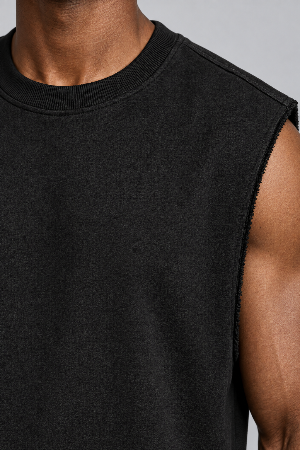 Detail of Raw Form Terry Tank in Black, showing the ribbed neckline, terry texture and frayed armhole edge.